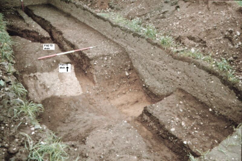 Plate 23. Trench 3. The 2nd C. ditch F141, cut by the 4th C. drain F142, a branch drain, coming in from the left, which almost certainly connects to F63 in S4.