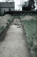Plate 20. Trench 8 showing ditch F148, wall remains F149 and the drain running through both. The shallow ditch in the foreground, which showed on the resistivity scan, is probably Iron Age.