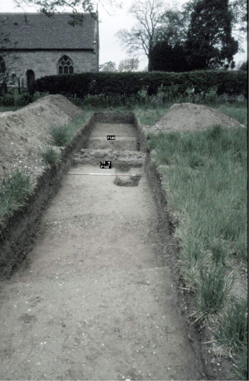 Plate 20. Trench 8 showing ditch F148, wall remains F149 and the drain running through both. The shallow ditch in the foreground, which showed on the resistivity scan, is probably Iron Age.